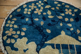 Close-up of antique Peking pictorial rug: tree, gazebo motif, rich blue, worn fringe.