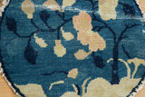 Antique Peking pictorial rug detail: blue ground, beige leaves, visible foundation, tattered edge.