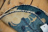 Tattered edges of an antique hand-knotted Peking rug, revealing cobalt blue and beige foundation.