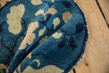 Antique Peking pictorial rug detail: expressive indigo and ivory leaves, mostly even pile wear, tattered edge.
