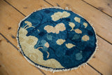 Cobalt blue and ivory pictorial motif with tattered edge on antique Peking rug.