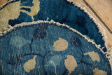 Detail of the hand-knotted weave and tattered sides of an antique Chinese Peking rug, blue and ivory.