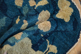 Antique Peking rug's hand knotted pile featuring cobalt blue, beige leaf motif, and tattered edge.