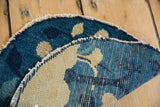 Antique Peking rug: hand-knotted foundation, deep blue pile, and tattered edges.