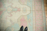 Distressed ivory, pink, and powder blue geometric arrow motifs.