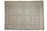 Vintage distressed Oushak carpet in soft blue, ivory, and beige with geometric medallions.