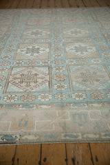 Pale blue, ivory, beige geometric floral panels on distressed Oushak rug corner.