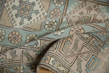 Textured Oushak pile with pale blue, ivory, beige floral guls and geometric motifs.