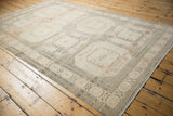 Vintage Sivas carpet detail: distressed ivory and beige with repeating geometric gul pattern.