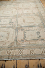Distressed Sivas carpet detail showing even wear, soft ivory, blush, and beige tones in a geometric pattern.