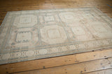 Distressed Sivas rug detail with geometric patterns, ivory, beige, and faint navy lines.