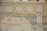 Distressed Sivas carpet corner showing geometric borders and muted blush field.