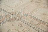 Distressed geometric pattern with navy, ivory, and beige on a Sivas carpet.