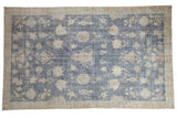 Distressed vintage Sparta carpet, allover floral tree-of-life patterns on faded blue.