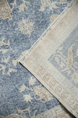 Distressed blue vintage Sparta carpet pile, folded to reveal its hand knotted foundation.