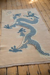 Distressed texture of dusty denim blue dragon scales and pale peach field.