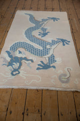 Textural fringe and blue five-claw dragon on a vintage distressed Tibetan rug.
