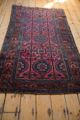 Large scale sapphire blue floral medallions on a rich raspberry red field of a Lilihan rug.