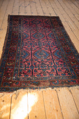 Vintage Lilihan rug with ruby red field and sapphire blue floral pendant medallions.