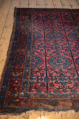 Tattered fringe, sapphire blue and wine red border of vintage Lilihan rug.