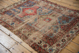 Threadbare antique Caucasian rug, revealing Avar geometric motifs in powder blue and terracotta.