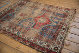 Antique Caucasian rug: powder blue and terracotta geometric motifs, with threadbare areas.