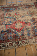 Close-up of geometric Avar design motifs, threadbare areas, and wear on an antique Caucasian rug.