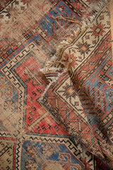 Worn pile with exposed foundation and geometric patterns on a circa 1910s antique Caucasian rug.