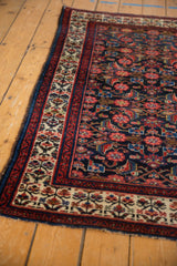 Vintage Malayer rug corner with intact blue selvage, blossomed plant border, Herati field.
