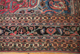 Vintage Doroksh carpet's borders with intricate floral patterns and sprawling vinery in rich jewel tones.