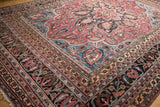 Intricate corner of the vintage Doroksh rug with ruby red, sapphire blue floral vinery.