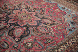 Dense ruby red and dark blue vinery on a vintage Persian Doroksh carpet.