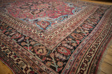 Ornate ruby red, sapphire blue, and ivory floral borders on a Vintage Doroksh carpet corner.