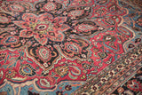 Ornate hand-knotted ruby red vinery, sapphire blue blossoms, and a patterned border.