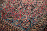 Vintage hand-knotted Doroksh rug: ruby red field, sapphire blue border, intricate floral vinery.