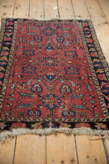 Vintage Lilihan rug field in raspberry red, showcasing sapphire blue floral vinery, rich patina.
