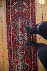 Vintage Karaja runner with geometric medallions and pinwheel designs in cherry red and navy blue.