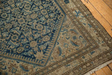 Corner detail of distressed vintage Malayer rug, with mostly even wear on Herati patterns, brown border.