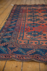 Hand-knotted Caucasian antique rug with geometric border in brick red and indigo blue.