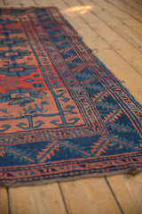 Antique Caucasian rug with geometric guls in brick red and indigo blue, showing knot wear.