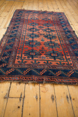 Antique Caucasian rug's worn fringe and indigo geometric border with visible knot heads.