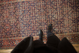 Antique Persian Fereghan carpet's Herati motif, displaying softened pile and rich tones underfoot.