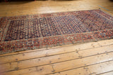 Antique Fereghan carpet detail: hand-knotted Herati motif, navy, brick red, green, and softened pile.