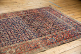 Antique Fereghan carpet close-up, Herati pattern in rich navy blue, brick red, and powder blue.