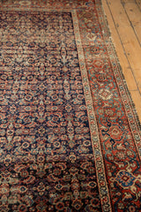 Antique Fereghan carpet's intricate navy Herati field texture and brick red border.