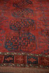Geometric border detail of antique Ersari carpet with chestnut red and navy blue.
