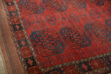 Antique Ersari carpet's chestnut red gul, navy Tree of Life vine, and original selvage.