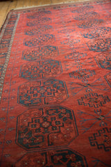Antique Ersari carpet with repeating guls, chestnut red field, and navy blue Tree of Life vines.