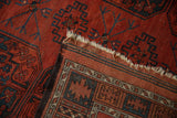 Antique Ersari carpet corner showing chestnut red pile, navy gul motifs, and striped woven reverse.