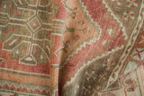 Distressed Oushak rug detail: even wear, muted raspberry, terracotta, and green patterns.